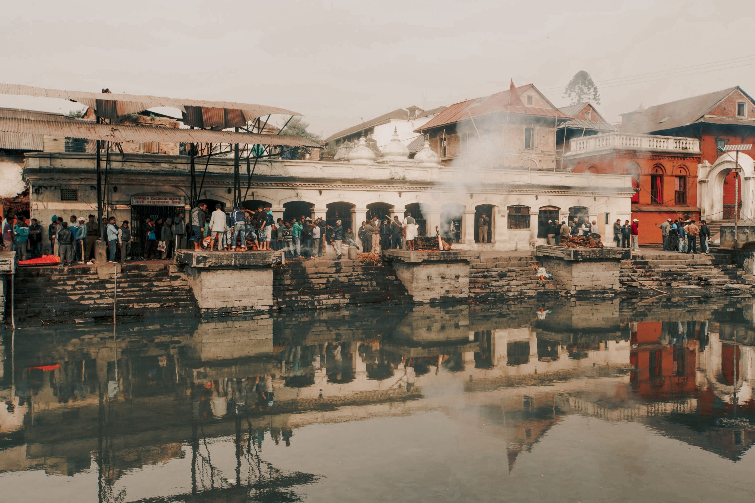 Cremation ceremonies at Pashupatinath Temple, Kathmandu, a sacred Hindu site by the Bagmati River.