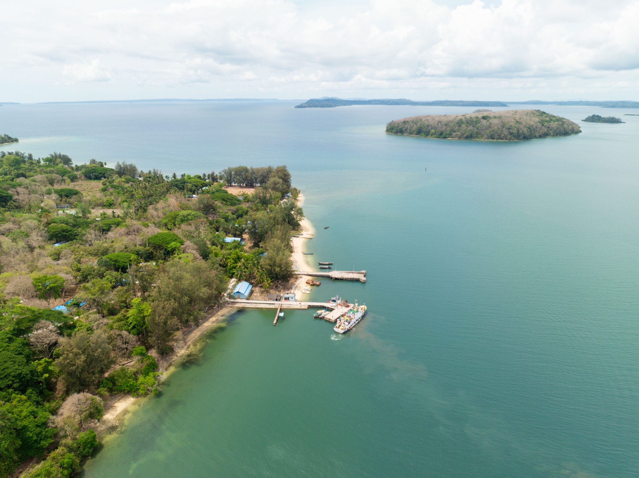 Scenic aerial shot of Andaman's lush coast and clear waters, showcasing its untouched beauty.